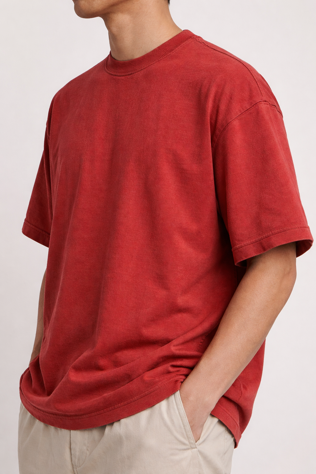 Person wearing a cherry red t-shirt on a white background
